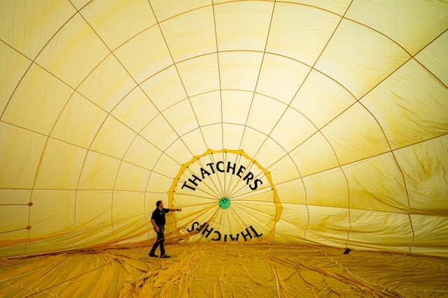 Hot air balloon pilots carry out checks before each flight (Ben Birchall/PA)