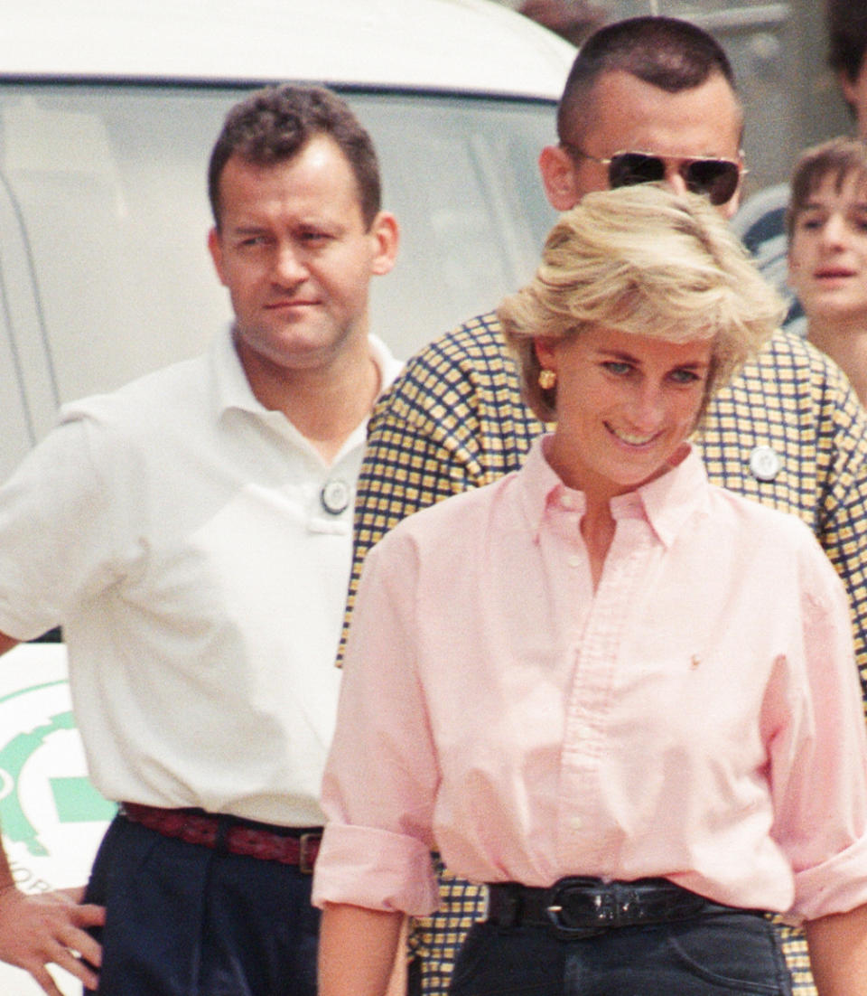 Paul Burrell (left, in the background in the white shirt and black trousers, butler to Diana, Princess of Wales as she makes a three day visit to Bosnia - Herzegovina as part of her campaign to raise awareness about the devastating effects landmines have on peoples lives and to call for a complete ban on the production, sale and use of land mines. The trip was organised by the American-based Landmine Survivors Network. Picture taken 10th August 1997. (Photo by Kent Gavin/Mirrorpix/Getty Images)