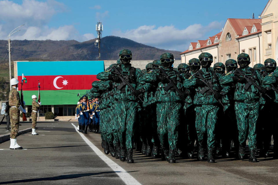 In this photo provided by the Azerbaijan's Presidential Press Office, troops march past Azerbaijani President Ilham Aliyev during a parade dedicated to the third anniversary of the Victory in the Patriotic War in Khankendi, also known by Armenians as Stepanakert, in Khankendi, Wednesday, Nov. 8, 2023. Azerbaijanis celebrate the third anniversary of their victory in the 2020 Nagorno-Karabakh war after Azerbaijan gained the full control over the separatist region in fighting earlier this year. (Azerbaijani Presidential Press Office via AP)