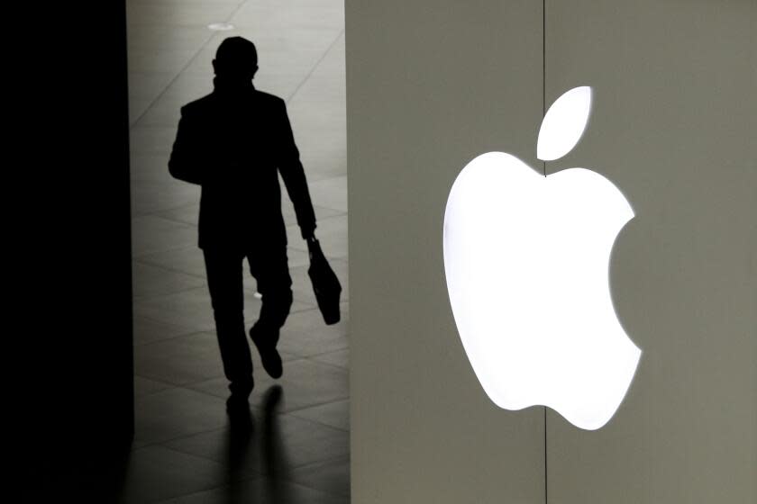 FILE - In this Jan. 3, 2019, file photo, a man leaves an Apple store in Beijing. Apple says it will roll out a new privacy control in spring 2021 to prevent iPhone apps from secretly shadowing people. (AP Photo/Andy Wong, File)