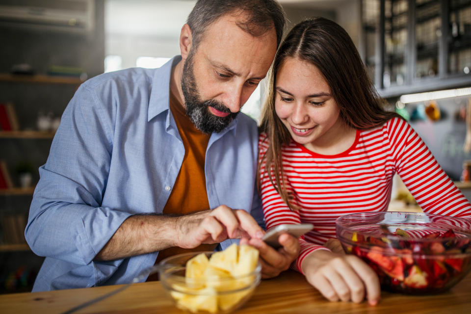 Photo of father with daughter surfing the net at the home