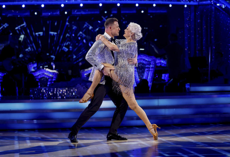 Kai Widdrington and Angela Rippon dance the cha-cha in matching silver outfits