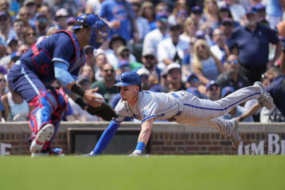 Kansas City Royals' Drew Waters, right, dives safely into home base past Chicago Cubs catcher Yan Gomes during the third inning of a baseball game Friday, Aug. 18, 2023, in Chicago. (AP Photo/Erin Hooley)