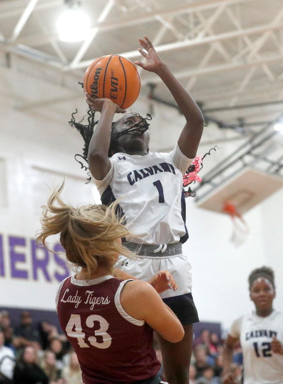 Calvary's Destini Gooddine goes up for a basket over Dawson County's Anna Ayers during the State quarterfinals on Tuesday February 28, 2023.