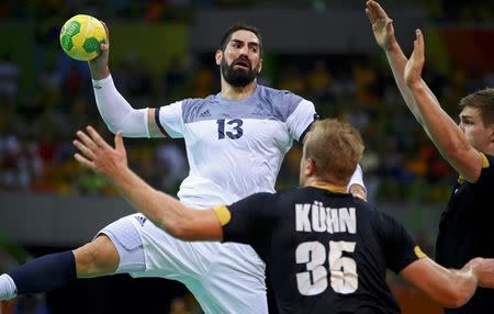 2016 Rio Olympics - Handball - Semifinal - Men's Semifinal France v Germany - Future Arena - Rio de Janeiro, Brazil - 19/08/2016. Nikola Karabatic (FRA) of France and Julius Kuhn (GER) of Germany in action. REUTERS/Marko Djurica