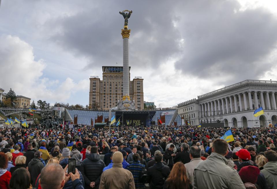 Protesters listen to a speaker during a rally in Independence Square in Kyiv, Ukraine, Sunday, Oct. 6, 2019. Thousands are rallying in the Ukrainian capital against the president's plan to hold a local election in the country's rebel-held east, a move seen by some as a concession to Russia. (AP Photo/Efrem Lukatsky)