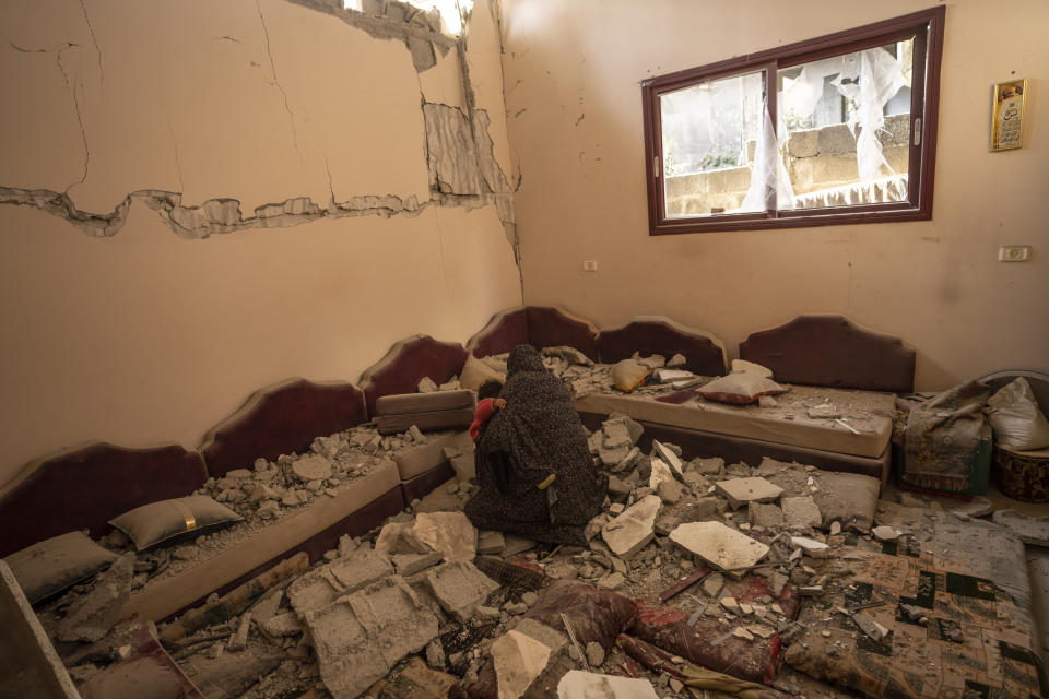 Members of the Abu Sinjar family inspect their house after it was hit by an Israeli airstrike in Rafah, southern Gaza Strip, Friday, Jan. 5, 2024. (AP Photo/Fatima Shbair)