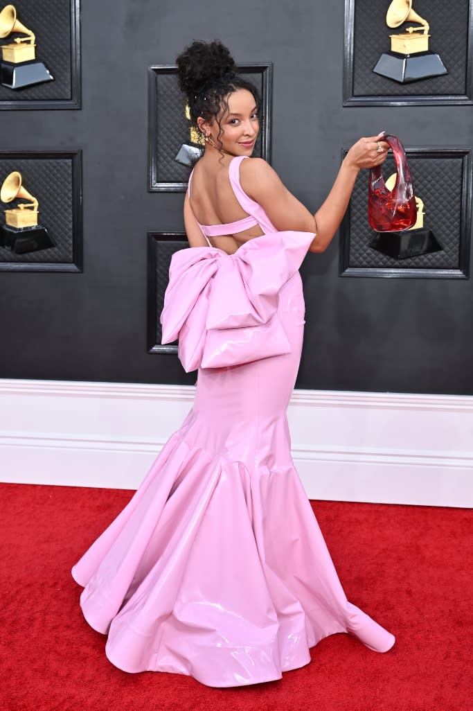 Tinashe strikes a pose on the Grammy’s red carpet to show off her GCDS gown’s statement bow. - Credit: Variety