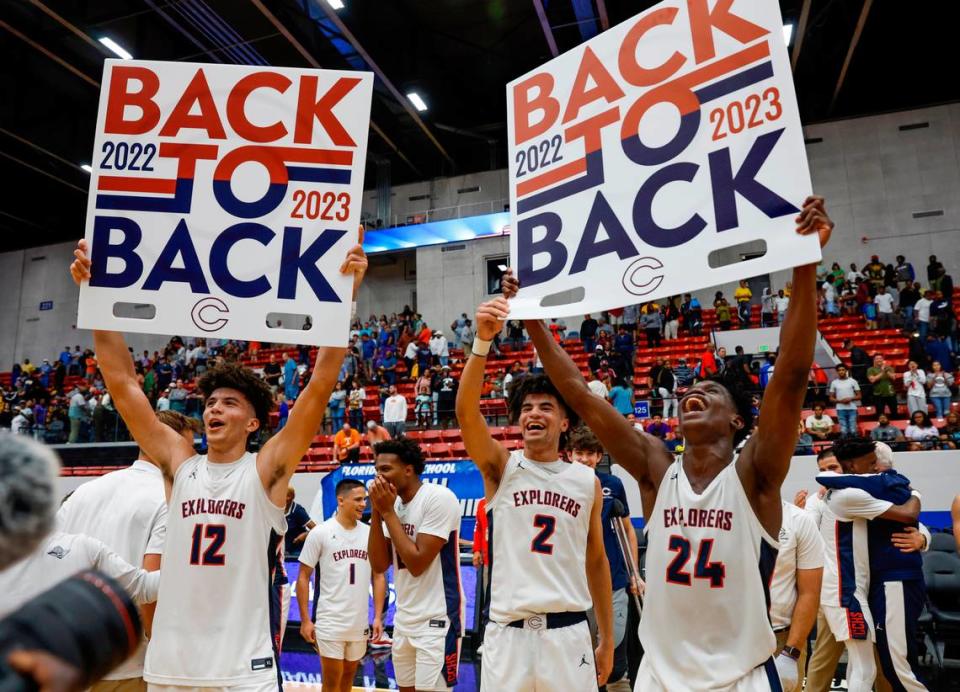 Columbus High School’s Cameron Boozer (12), Cayden Boozer (2), and Malik Abdullahi (24) celebrate their back to back State Titles during the FHSAA boys basketball Class 7A State Championship at the RP Funding Center in Lakeland, Florida on Saturday, March 4, 2023.