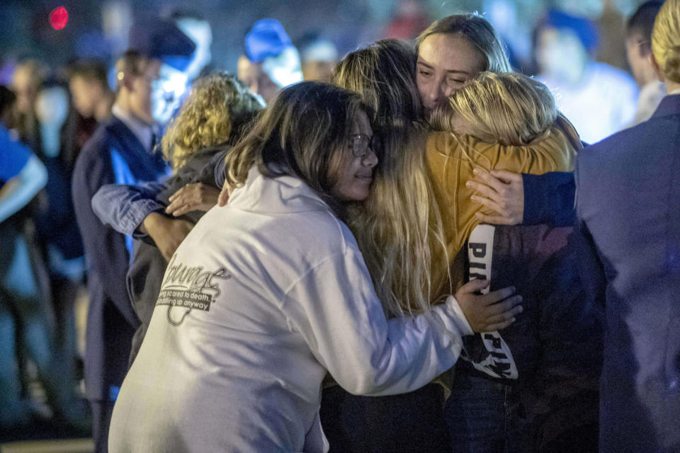 People hug each other during a vigil for the Saugus High School shooting victims at Central Park, Thursday, Nov. 14, 2019, in Santa Clarita, Calif. Los Angeles County sheriff’s officials say a 16-year-old student shot several classmates and then himself in a quad area of Saugus High School Thursday morning. (Hans Gutknecht/The Orange County Register/SCNG via AP)