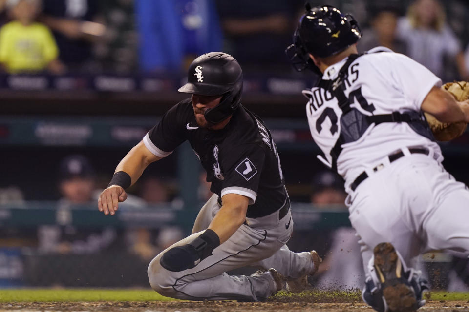 Chicago White Sox's Danny Mendick beats the throw to Detroit Tigers catcher Jake Rogers to score during the 10th inning of a baseball game, Friday, June 11, 2021, in Detroit. (AP Photo/Carlos Osorio)