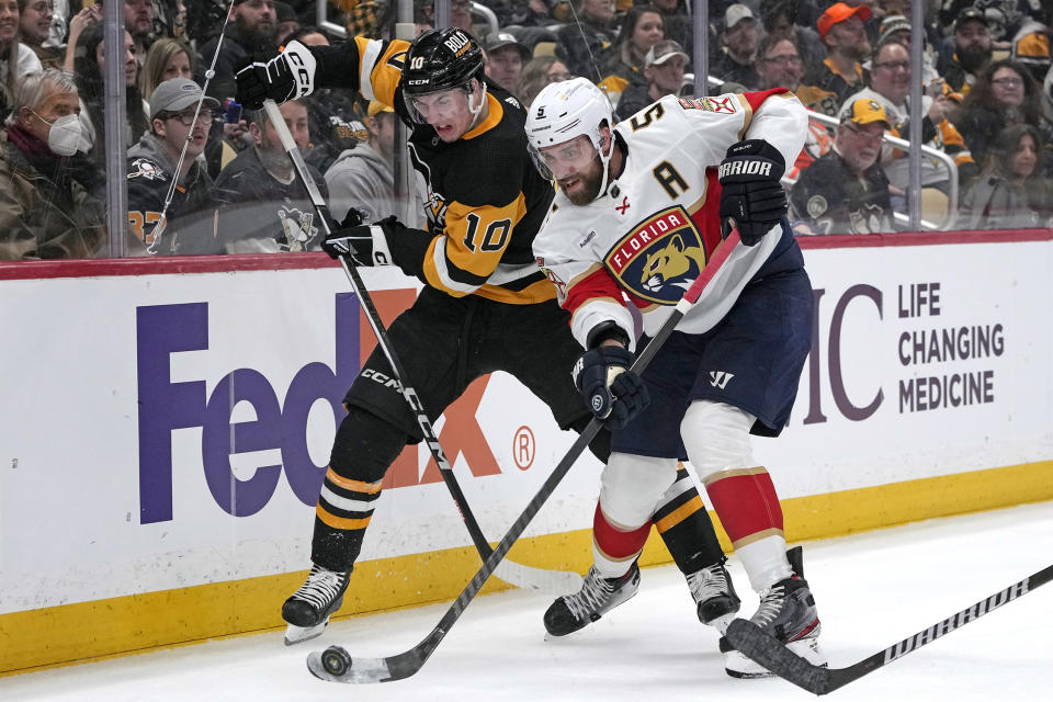 Florida Panthers' Aaron Ekblad (5) clears the puck while defending against Pittsburgh Penguins' Drew O'Connor during the second period of an NHL hockey game in Pittsburgh, Friday, Jan. 26, 2024. (AP Photo/Gene J. Puskar)