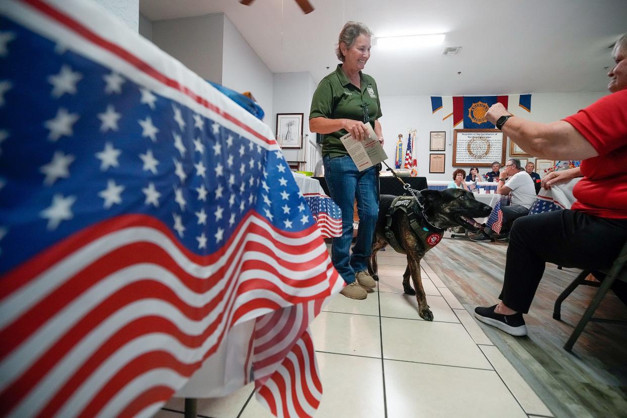 Shawn Salvi, accompanied by her service dog Axel speaks during an event to honor female veterans at American Legion Post 285 in Edgewater, Saturday, Nov. 4, 2023.