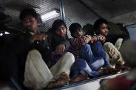 Indian passengers settle inside an overcrowded train in New Delhi, India.