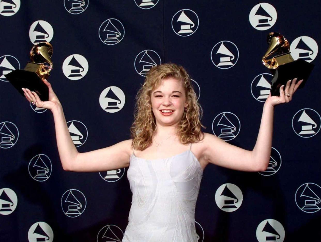 LeAnn Rimes holds up her two Grammy Awards on February 26, 1996, in New York. Rimes won for best female country singer and best women's vocal new artist. 