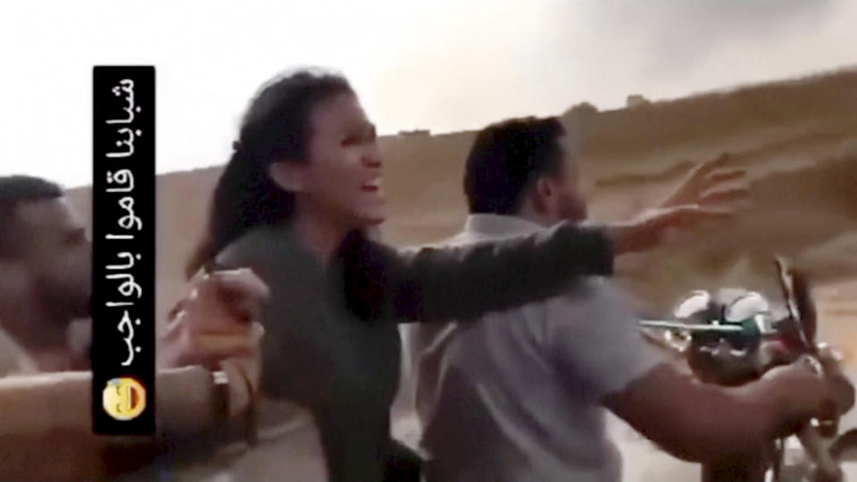 In this image from video obtained by the AP, Noa Argamani reacts as she and her partner Avinatan Or, not pictured, are seized by members of the Hamas militant group during an incursion into Israel on Saturday, Oct. 7, 2023. Israeli media reported that the couple had been attending a dance music festival in the desert when militants overran the area. The writing in Arabic at left in the video posted on social media reads, "Our guys have done their duty" (AP Photo)