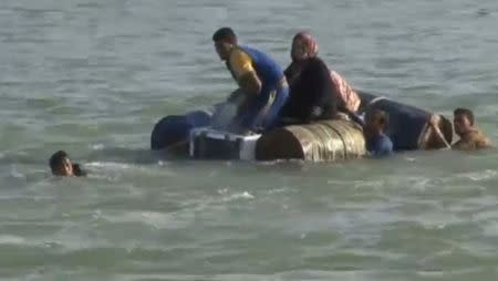 A still image from video released June 6, 2016 shows Iraqi families attempting to escape the besieged city of Falluja, Iraq, by crossing the Euphrates river, June 3, 2016. via REUTERS TV