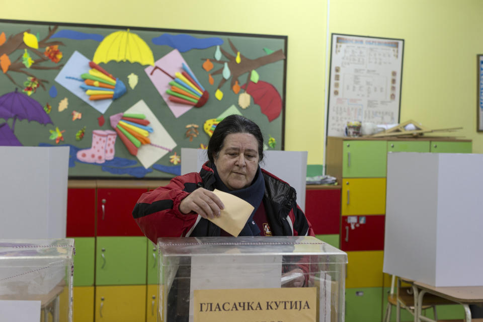 A woman casts her vote at the early parliamentary elections in Belgrade, Serbia, Sunday, Dec. 17, 2023. Serbia's populist President Aleksandar Vucic is looking to further tighten his firm grip on power in the Balkan state in an election on Sunday that has been marred by reports of major irregularities during a tense campaign. (AP Photo/Marko Drobnjakovic)