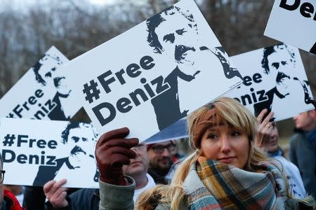 Protestors carry placards during a demonstration to support arrested German-Turkish journalist Deniz Yucel outside theTurkish Embassy in Berlin, Germany, February 28, 2017. REUTERS/Fabrizio Bensch -