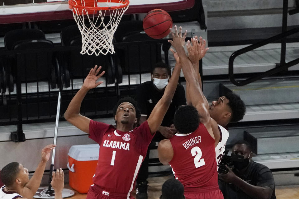 Mississippi State forward Tolu Smith, right, works against Alabama forwards Herbert Jones (1) and Jordan Bruner (2) for a rebound during the first half of an NCAA college basketball game in Starkville, Miss., Saturday, Feb. 27, 2021. (AP Photo/Rogelio V. Solis)