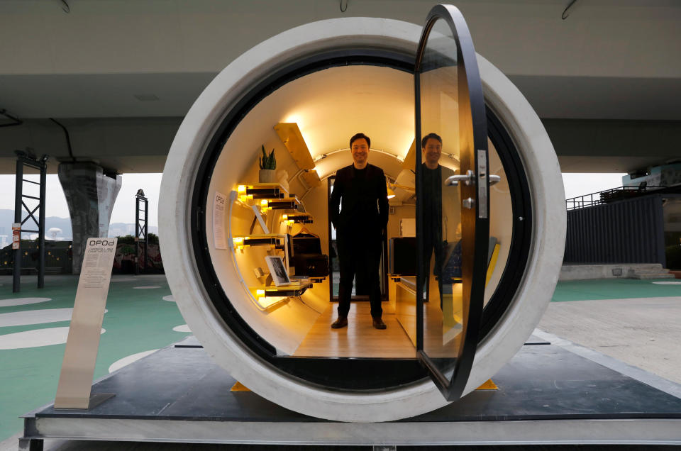 Architect James Law poses inside an OPod water pipe apartment (REUTERS/Tyrone Siu)