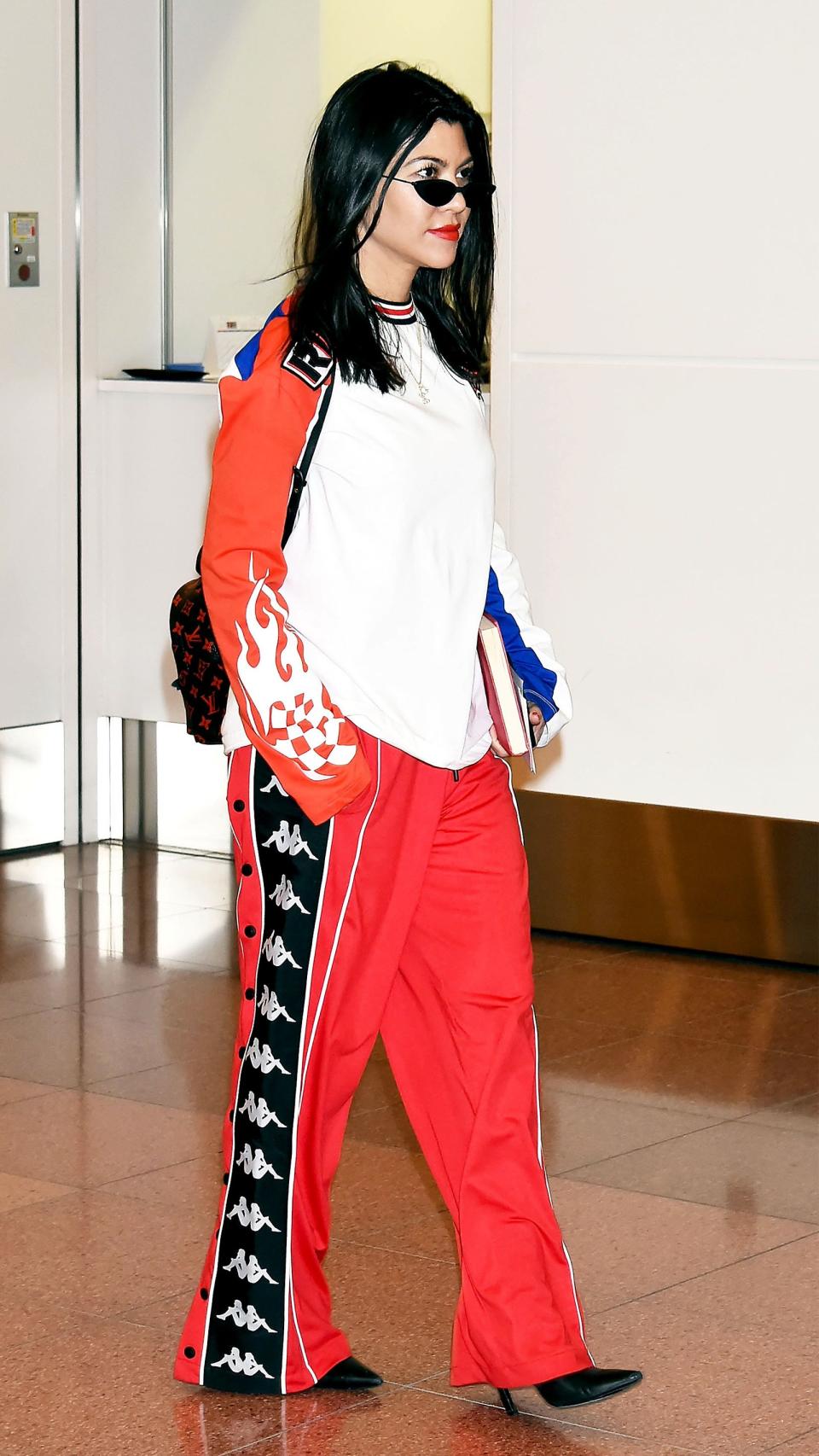 The travel take on a high-low mix: comfy track pants for hours on the plane, pointy-toe boots to strut off after landing.