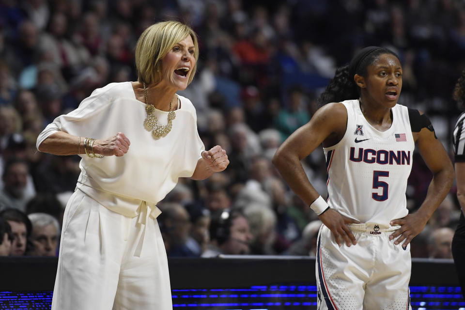 Connecticut associate head coach Chris Dailey, left, and Connecticut's Crystal Dangerfield react in the first half of an NCAA college basketball game against Oklahoma, Sunday, Dec. 22, 2019, in Uncasville, Conn. (AP Photo/Jessica Hill)