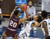 Texas Southern guard Michael Weathers (20) drives the ball into the defense of Mount St. Mary's guard Damian Chong Qui (15) during the second half of a First Four game in the NCAA men's college basketball tournament Thursday, March 18, 2021, in Bloomington, Ind. (AP Photo/Doug McSchooler)