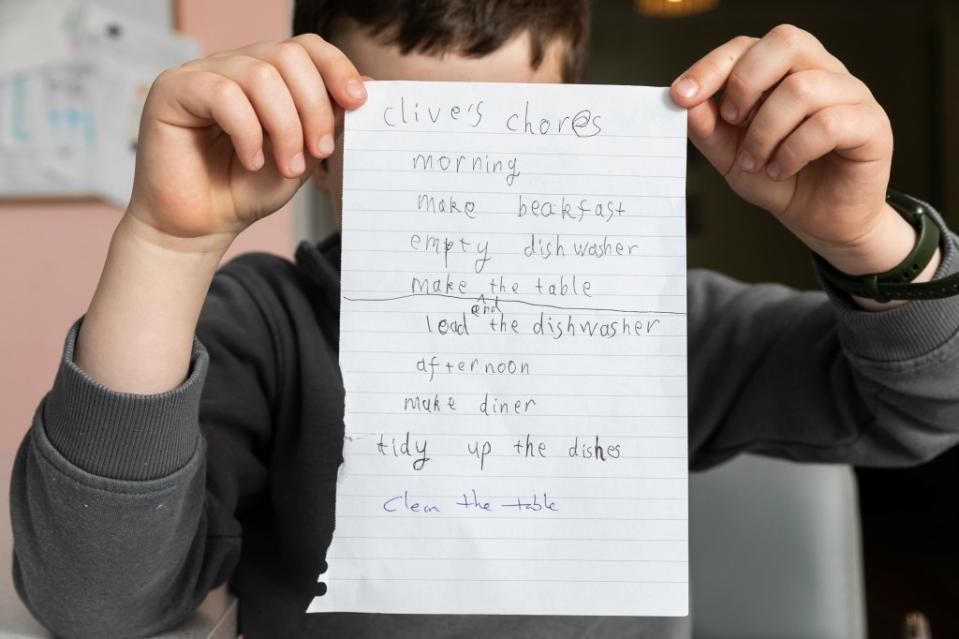 Clive with his chore list. Lee McLean / SWNS