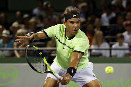 Mar 29, 2017; Miami, FL, USA; Rafael Nadal of Spain hits a volley against Jack Sock of the United States (not pictured) on day nine of the 2017 Miami Open at Crandon Park Tennis Center. Nadal won 6-2, 6-3. Mandatory Credit: Geoff Burke-USA TODAY Sports