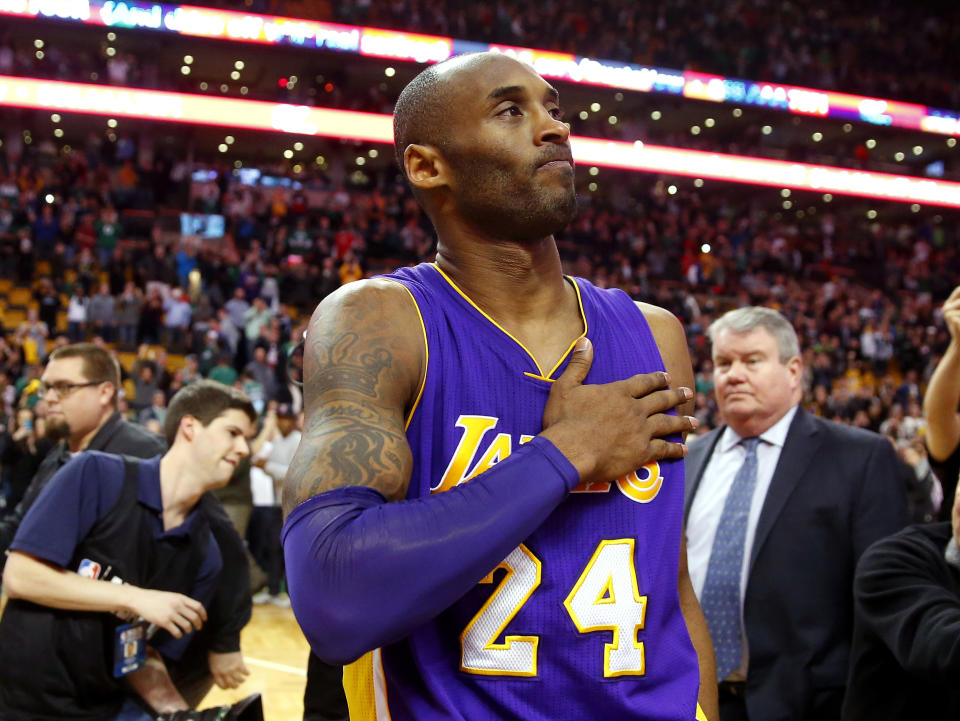 FILE - In this Dec. 30, 2015, file photo, Los Angeles Lakers' Kobe Bryant touches his chest as he walks off the court in Boston after the Lakers' 112-104 win over the Boston Celtics in an NBA basketball game. Kobe Bryant's legacy may be stronger than ever. Tuesday, Jan. 26, 2021, marks the anniversary of the crash that took the lives of Bryant, his daughter Gianna and seven other people. (AP Photo/Winslow Townson, File)