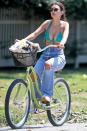 <p>Emily Ratajkowski rides through The Hamptons, New York, on Wednesday wearing a green bikini top and jeans.</p>