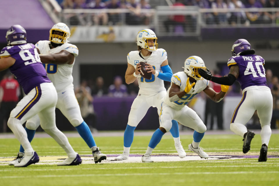 Los Angeles Chargers quarterback Justin Herbert (10) throws a pass during the first half of an NFL football game against the Minnesota Vikings, Sunday, Sept. 24, 2023, in Minneapolis. (AP Photo/Abbie Parr)