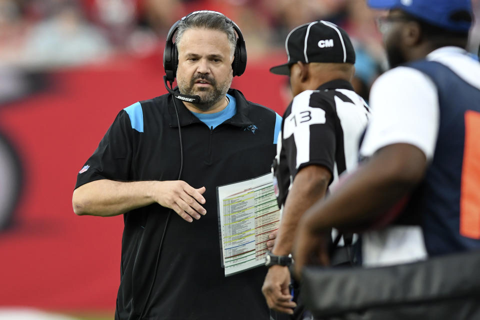 Carolina Panthers head coach Matt Rhule talks to down judge Patrick Turner (13) during the first half of an NFL football game against the Tampa Bay Buccaneers Sunday, Jan. 9, 2022, in Tampa, Fla. (AP Photo/Jason Behnken)