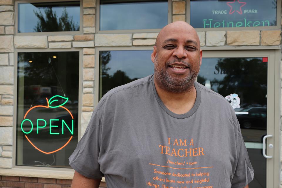 Chad Simmons, the newest member of Iowa City's Ad Hoc Truth and Reconciliation Commission, poses for a photo in front of Sugapeach Chicken & Fish Fry, the business he co-founded with his wife on Thursday, Aug. 3, 2023.