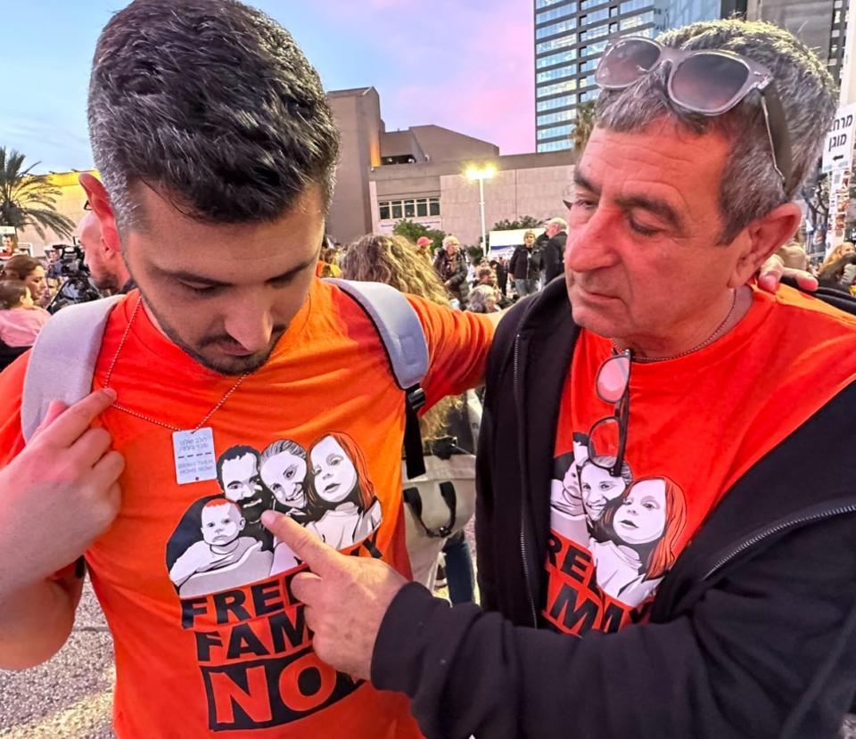 Eli Bibas points to a T-shirt image of his kidnapped son, Yarden, who remains held in Gaza with wife Shiri and their children, Ariel, 4, and Kfir, 1, the two youngest hostages.