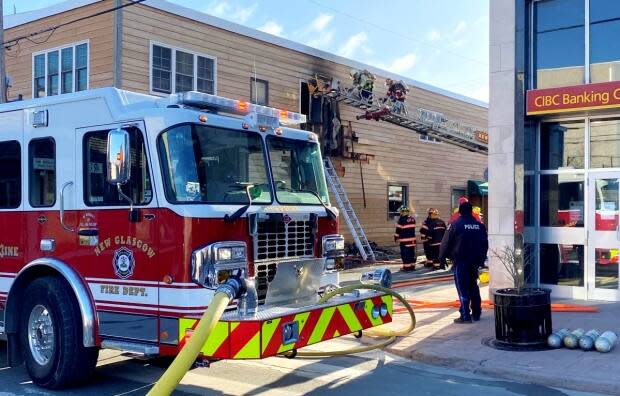 Fire crews battle a blaze at a business and residential complex on Provost Street in New Glasgow on Sunday. (New Glasgow Regional Police - image credit)