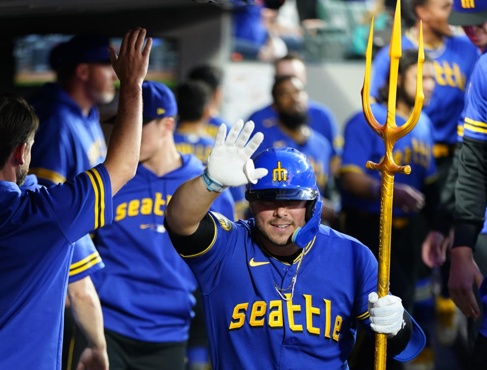 Seattle Mariners' Ty France holds a trident in the dugout after hitting a solo home run against the Baltimore Orioles during the fifth inning of a baseball game Friday, Aug. 11, 2023, in Seattle. (AP Photo/Lindsey Wasson)