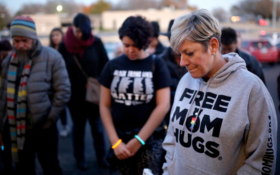 Sara Cunningham bows her head during a prayer Nov. 20, 2018, at a Transgender Day of Remembrance walk and vigil in Oklahoma City.