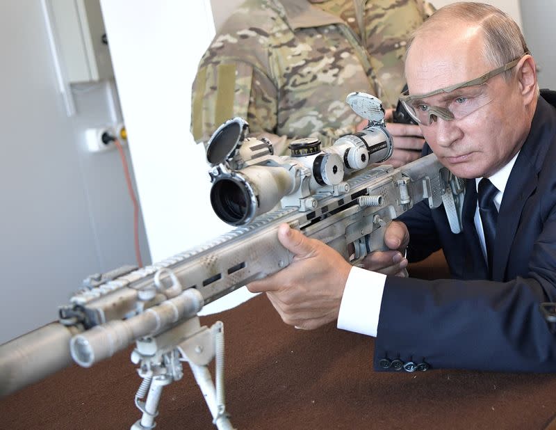 FILE PHOTO: Russian President Putin aims a Chukavin sniper rifle SVCh-308 at Patriot military theme park outside Moscow