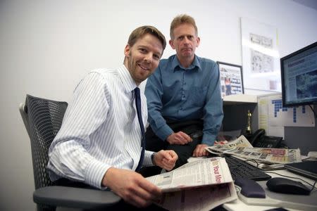 Journalists Darryl Smith (L) and Gavin Sherriff pose for a photograph in The Sunday Post building in Fleet Street in London, Britain August 5, 2016. REUTERS/Neil Hall