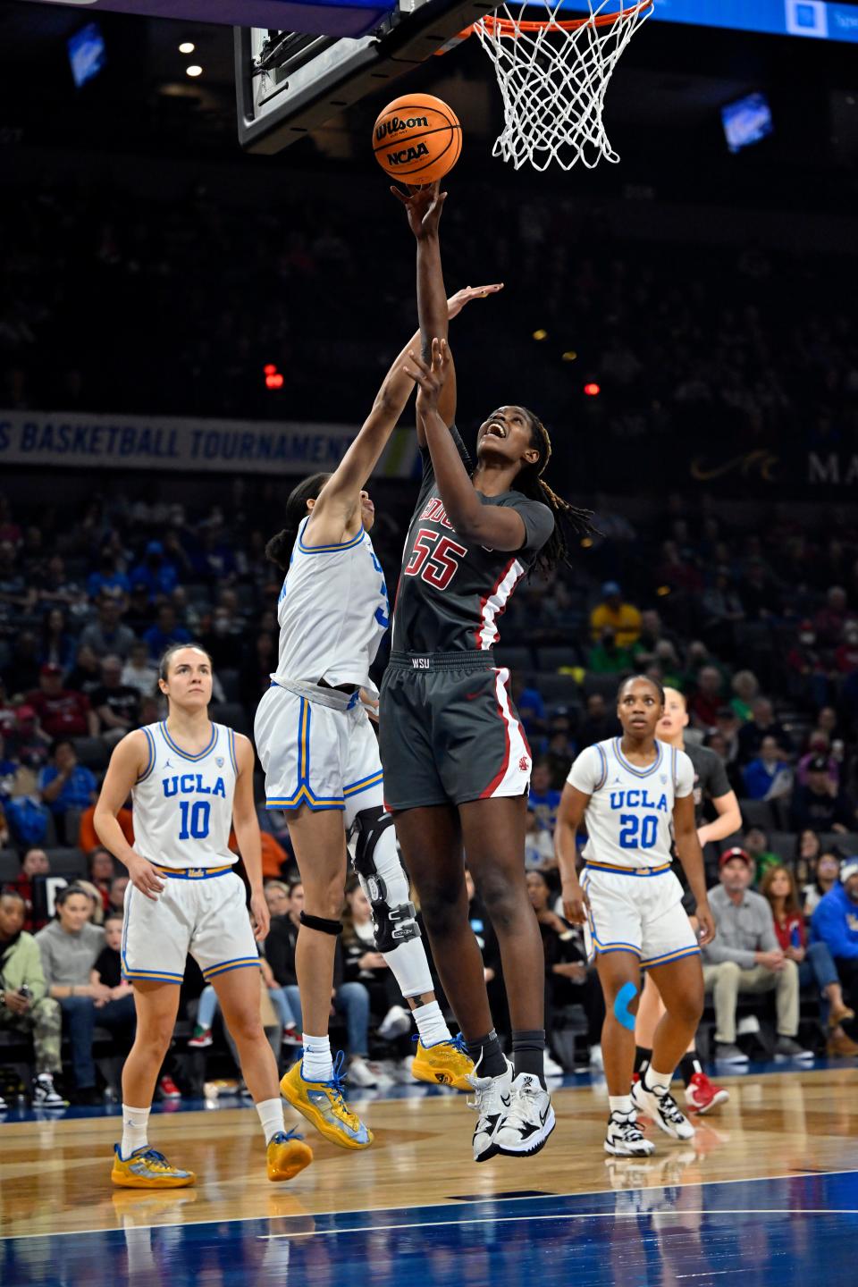 Washington State center Bella Murekatete (55) shoots against UCLA guard Camryn Brown during the first half of an NCAA college basketball game in the finals of the Pac-12 women's tournament Sunday, March 5, 2023, in Las Vegas. (AP Photo/David Becker)