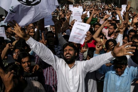 Kashmiris attend a protest after Eid-al-Adha prayers at a mosque during restrictions after the scrapping of the special constitutional status for Kashmir by the Indian government, in Srinagar