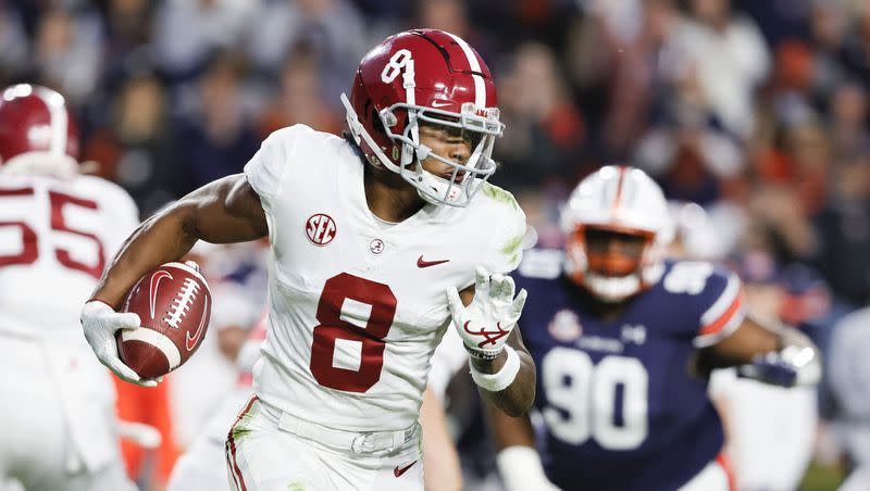 Alabama wide receiver John Metchie III (8) carries the ball against Auburn during an NCAA college football game Saturday, Nov. 27, 2021, in Auburn, Ala.
