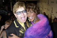 <p>Icons only! Elton John and Whitney Houston shared a laugh and a hug for the camera at Elton's infamous Oscar party. </p>