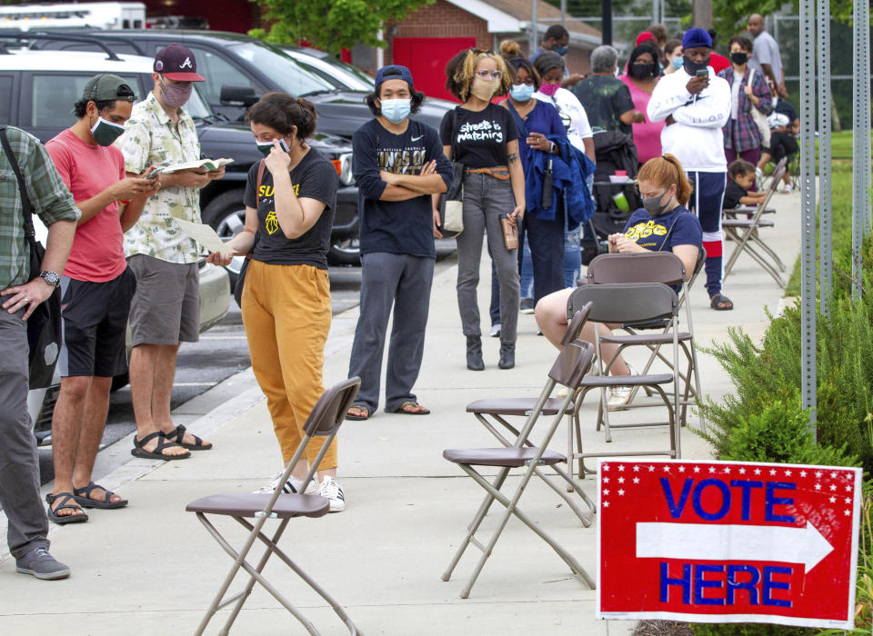 Voters wait in a line that stretched around the Metropolitan Library in Atlanta, Georgia, Tuesday, June 9, 2020. (Steve Schaefer/Atlanta Journal-Constitution via AP)