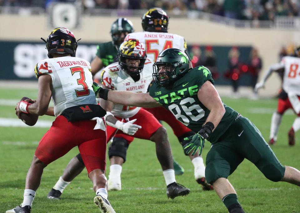 Michigan State Spartans defensive end Drew Beesley (86) rushes against Maryland Terrapins quarterback Taulia Tagovailoa (3) during first half action Saturday, Nov. 13, 2021 at Spartan Stadium.