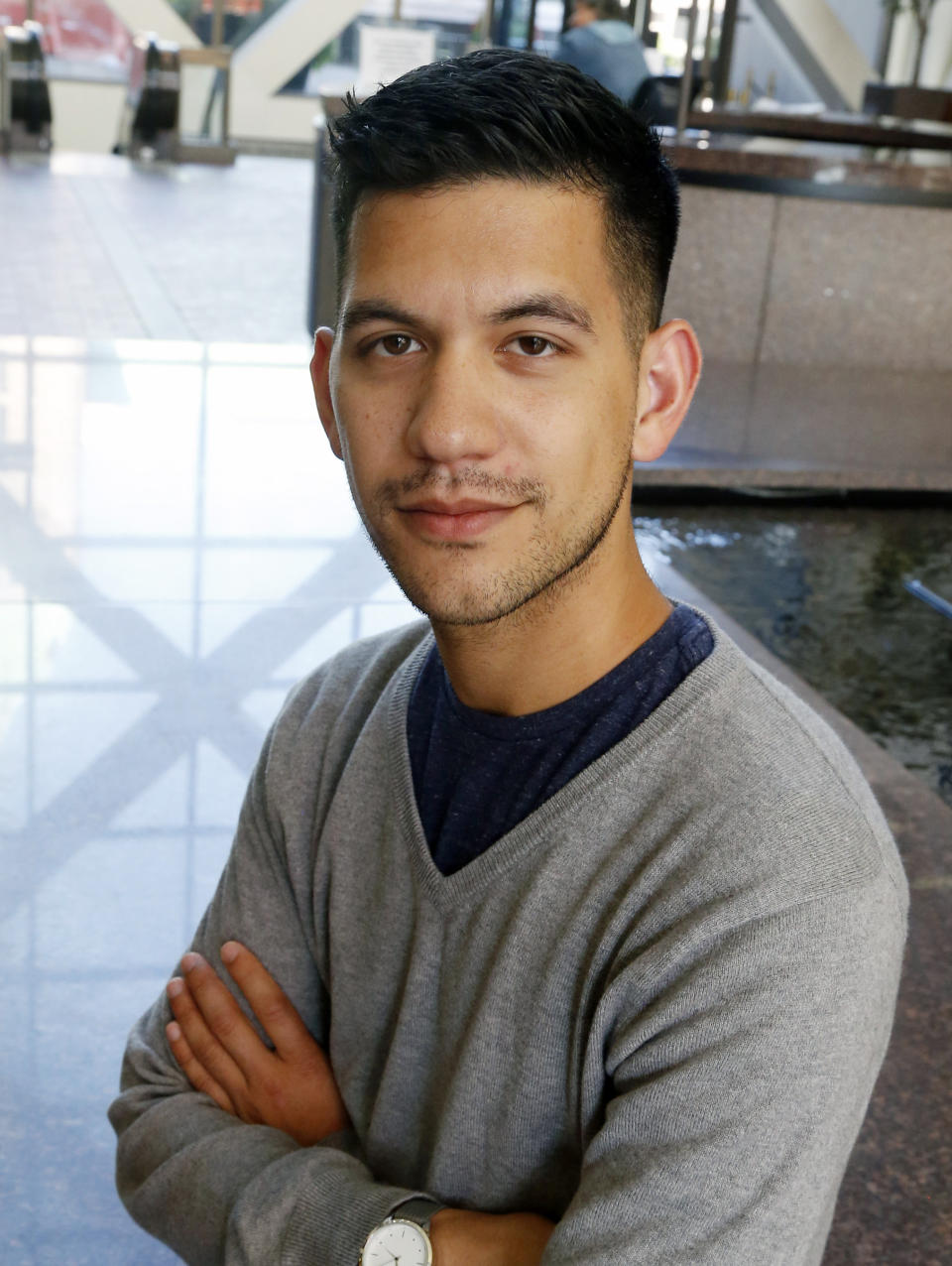 In this Friday, Sept. 7, 2018 photo, Chris Damian poses in Minneapolis. Damian believes having more nuanced conversations about hard topics like sex abuse by priests and allegations of cover-ups by church leaders can bring about change. Damian, 27, has organized a group of Catholic young adults to respond to the church crisis. (AP Photo/Jim Mone)