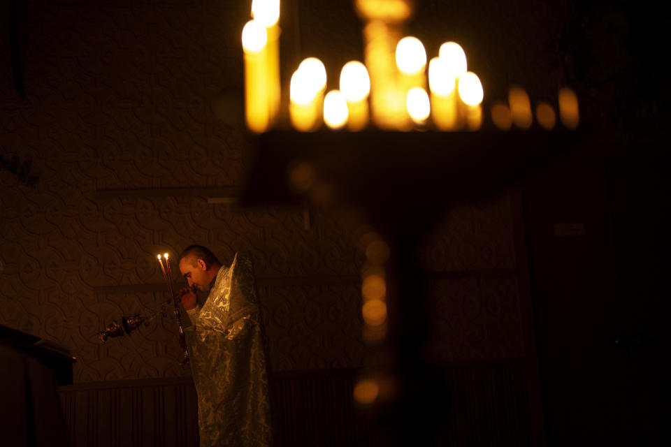 Priest Ivan, chaplain of the 72nd Separate Mechanized Brigade of the Ukrainian army, leads a Christian Orthodox Easter religious service, in Donetsk region, Ukraine, Saturday, May 4, 2024. (AP Photo/Francisco Seco)