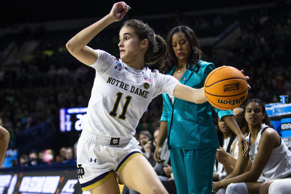 FILE - Notre Dame's Sonia Citron (11) keeps the ball in play as coach Niele Ivey watches her feet during the second half of the team's second-round college basketball game against Mississippi State in the women's NCAA Tournament, Sunday, March 19, 2023, in South Bend, Ind. (AP Photo/Michael Caterina, File)